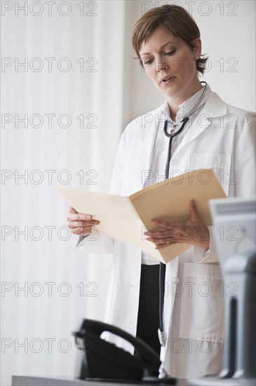Female doctor reviewing notes.