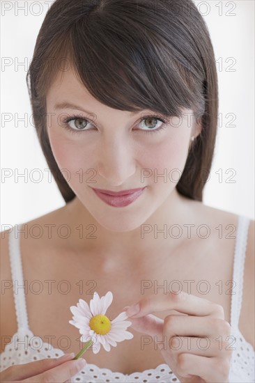 Woman plucking daisy.