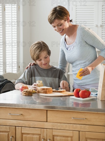 Mother and child preparing food.