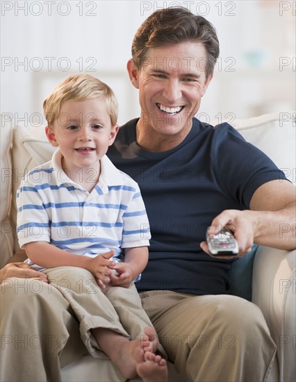 Father and child watching TV.