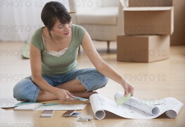 Woman looking at plans.