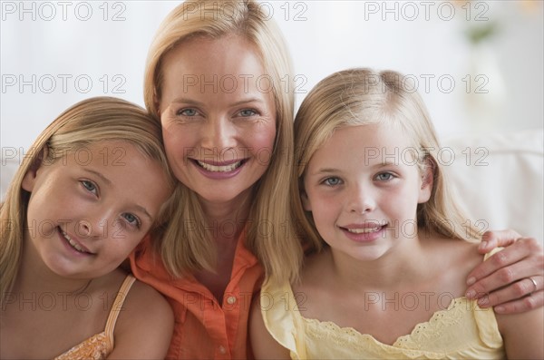 Mother and daughters at home.