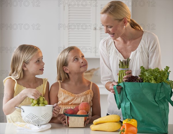 Mother and daughters in the kitchen.
