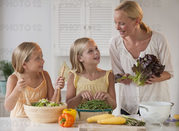 Mother and daughters in the kitchen.