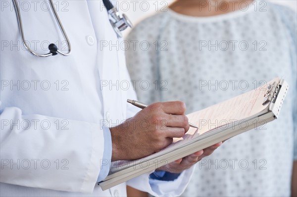 Doctor studying patient chart.