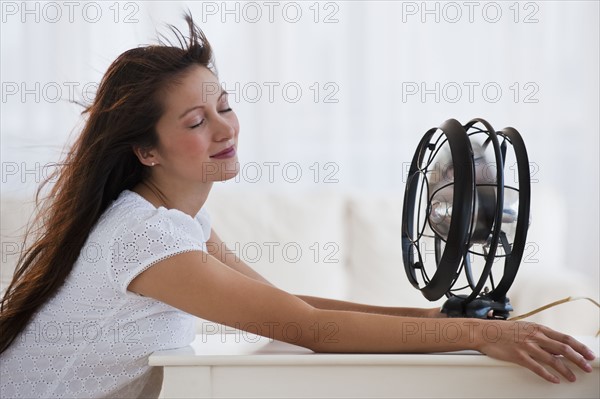 Fan blowing woman's face