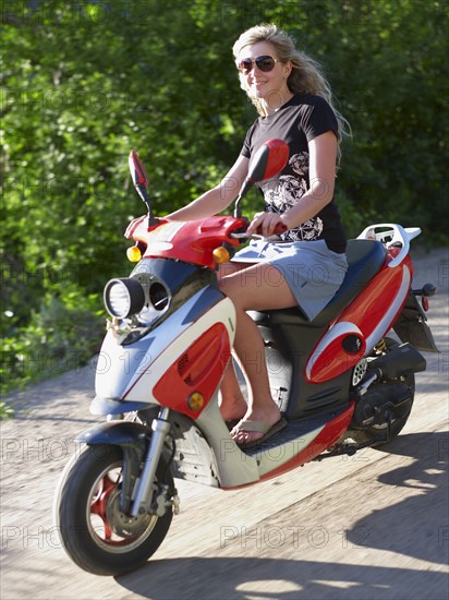 Young woman on scooter