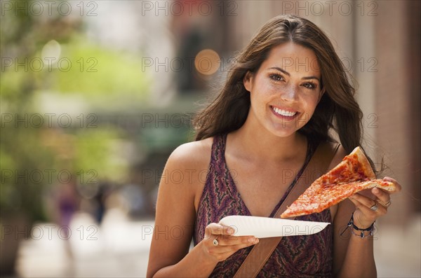 Woman eating pizza