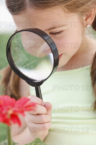 Child looking through magnifying glass