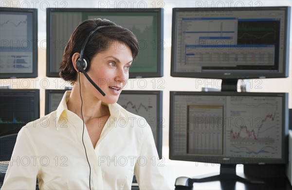 Female trader on headset.