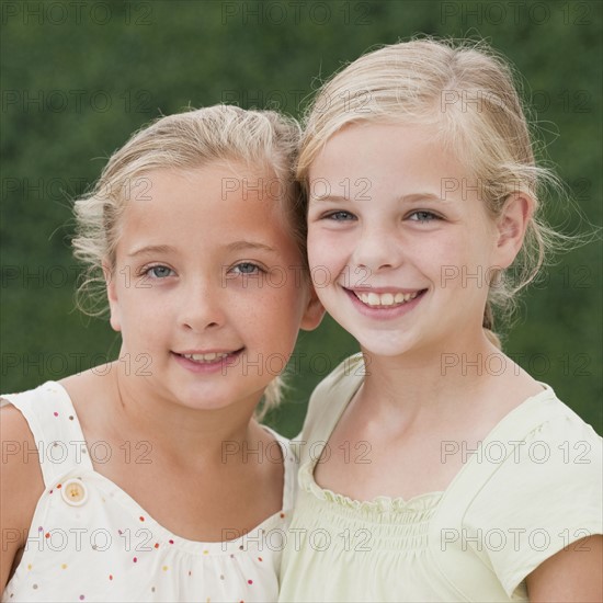 Young sisters smiling.