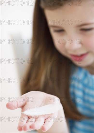 Child holding feather