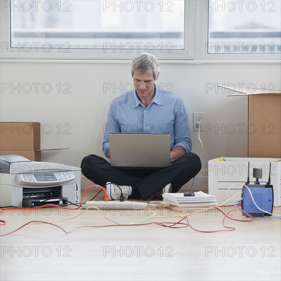 Man sitting while working on computer network.