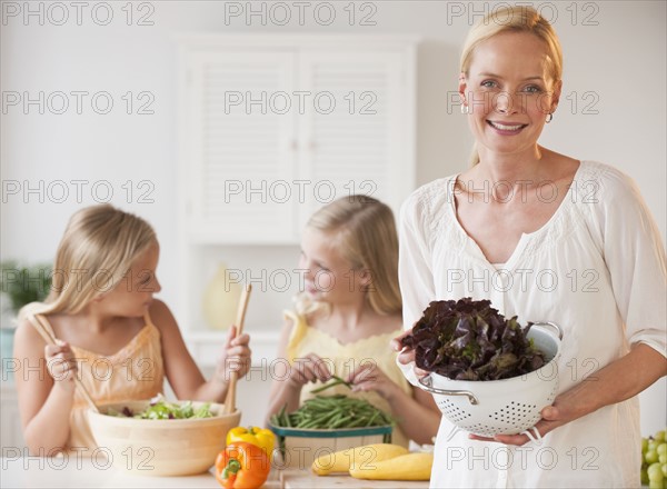 Mother and daughters in the kitchen.