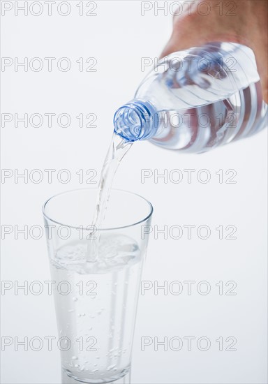 Pouring glass of water.