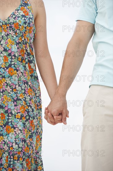 Couple holding hands.