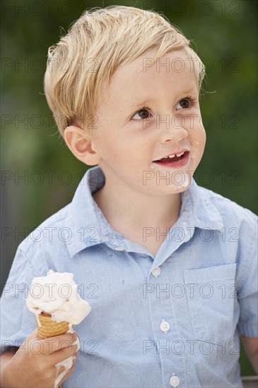 Child eating ice cream cone.