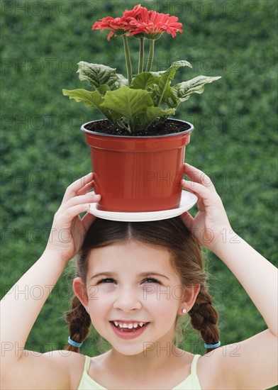 Child with plant on head