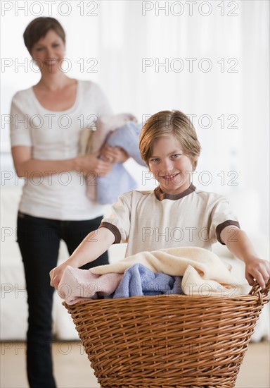 Mother and child doing laundry.
