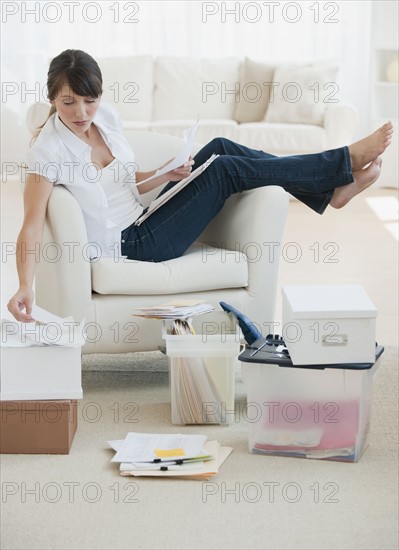 Woman organizing papers at home.