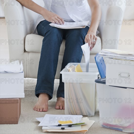 Woman shredding papers.