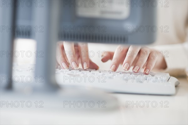 Hands typing on keywords.