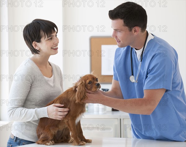 Vet and owner with dog.