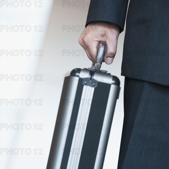 Businessman holding briefcase.