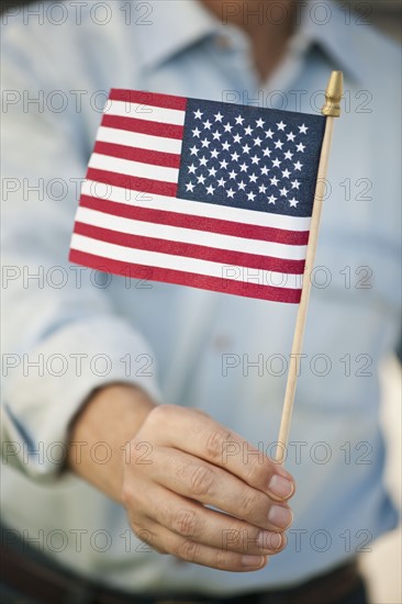 Man carrying American flag.