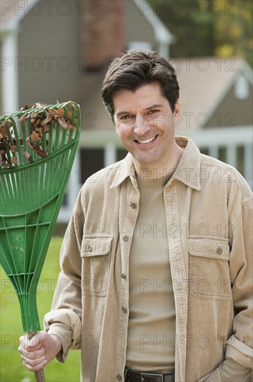 Man holding rake.