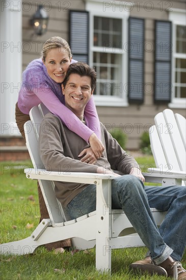 Couple in front of house.