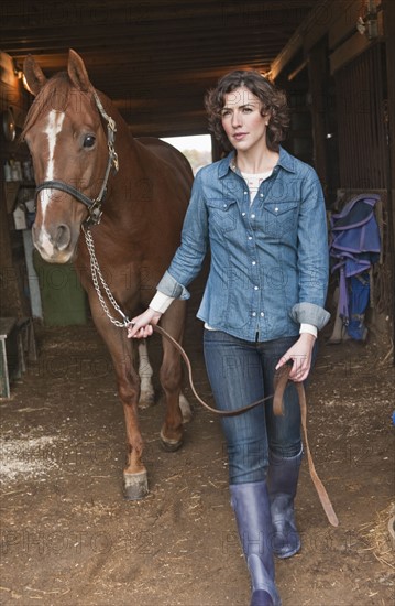 Woman leading horse.