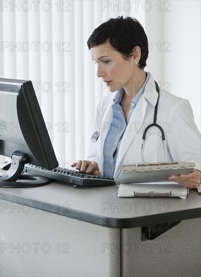 Doctor working on computer.