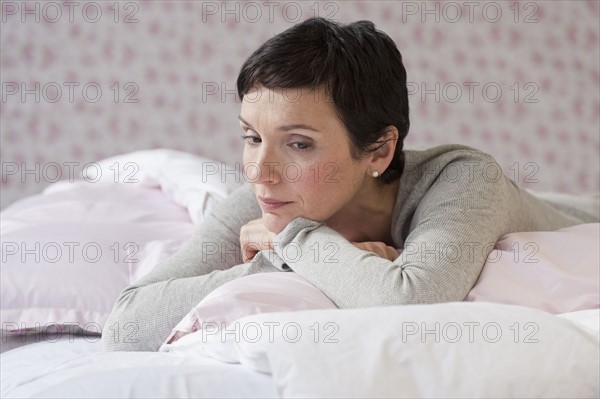 Woman lying on bed.