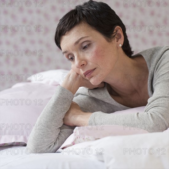 Woman lying on bed.