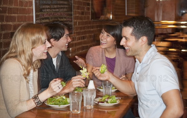 Friends eating at restaurant.