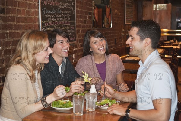 Friends eating at restaurant.