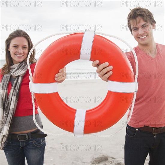 Couple holding life ring