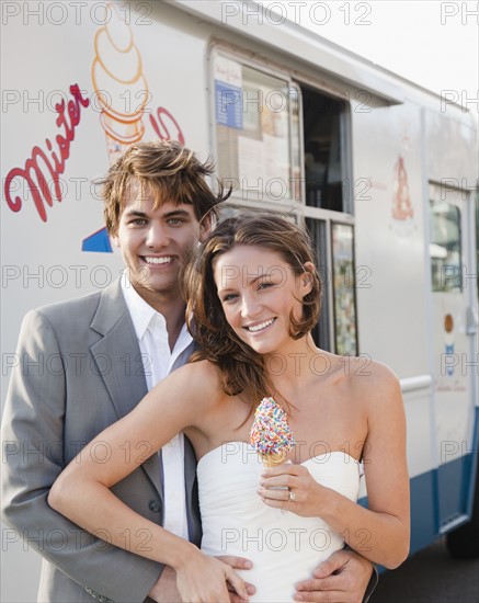 Bride and groom eating ice cream