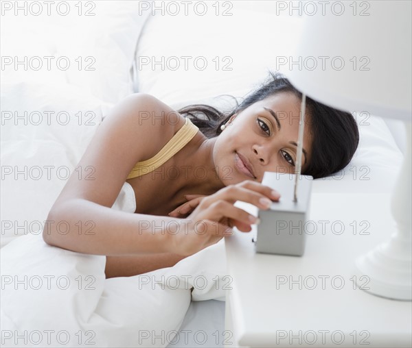 Woman setting alarm clock