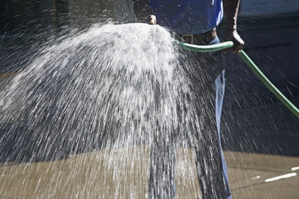 Man spraying hose