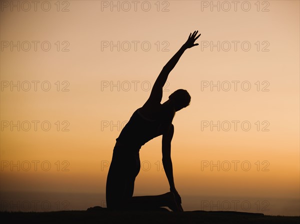 Silhouette of person stretching