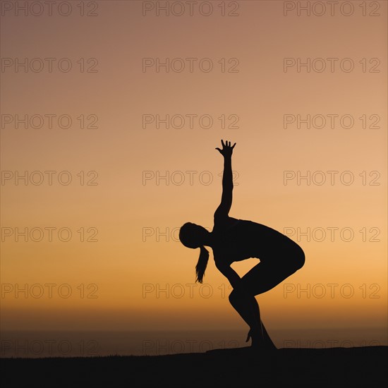 Silhouette of woman doing yoga