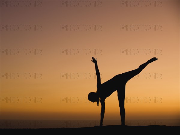 Silhouette of woman doing yoga