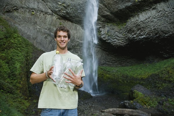 Man holding empty water bottles