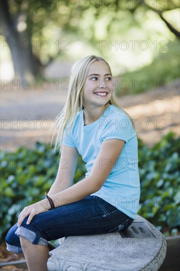 Young girl sitting on bench