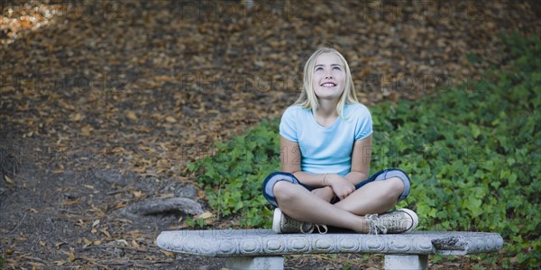 Young girl sitting on bench