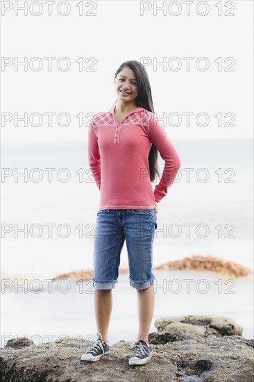 Girl standing in front of ocean