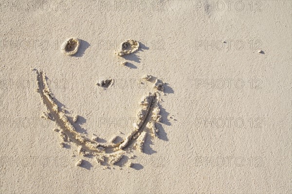 Happy face in the sand