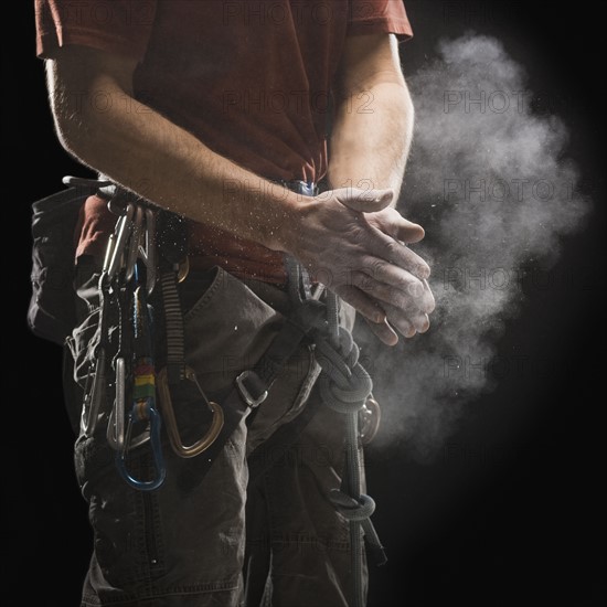 Male climber applying chalk to hands